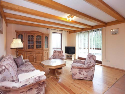 a living room with two couches and a coffee table at Quaint Holiday Home in G ntersberge near Lake in Güntersberge
