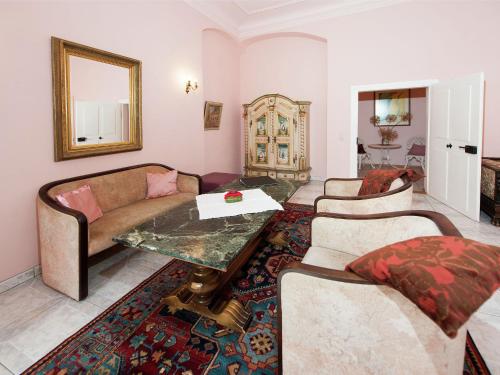 a living room with a couch and a table at Vintage Apartment in Arzberg Triestewitz in Arzberg