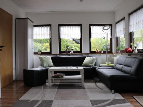 a living room with a couch and a table at Holiday Home in Mielinghausen with Garden Terrace in Reiste