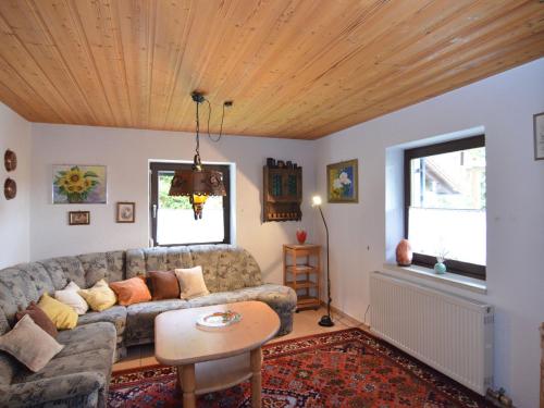 a living room with a couch and a wooden ceiling at Holiday home in Saldenburg with sauna in Saldenburg