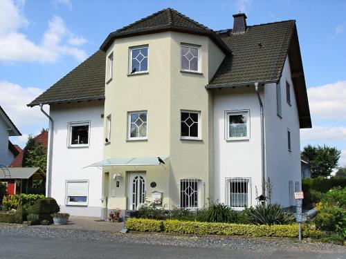 a large white house with a black roof at Apartment with private terrace in Runkel in Ennerich