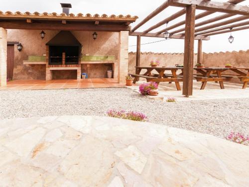 an outdoor patio with a picnic table and a grill at Cottage in Maians with Sea View & Pool in Castellfullit del Boix