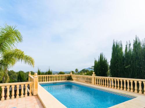 a swimming pool with a fence around it at Belvilla by oyo villa in Pedreguer