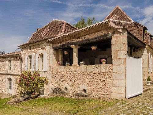 a stone house with a white door in a yard at Mansion in Sourzac with Private Pool in Sourzac