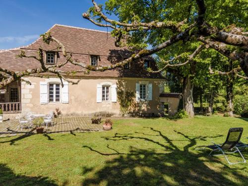 a house with a yard with a tree at Mansion in Sourzac with Private Pool in Sourzac