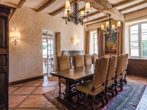 a dining room with a wooden table and chairs at Mansion in Sourzac with Private Pool in Sourzac