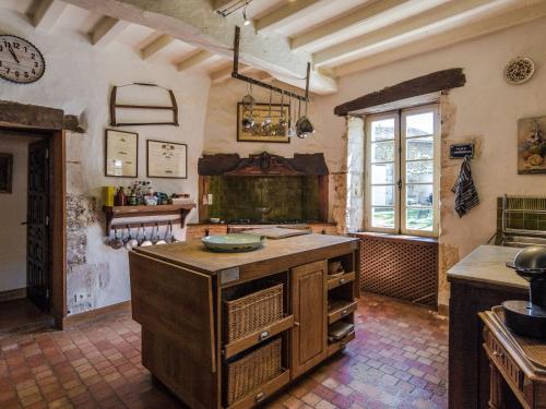 a kitchen with an island in the middle of a room at Mansion in Sourzac with Private Pool in Sourzac