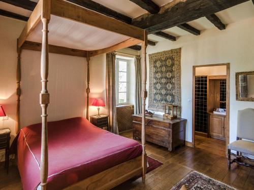 a bedroom with a canopy bed and a desk at Mansion in Sourzac with Private Pool in Sourzac