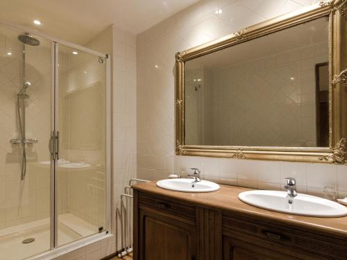 a bathroom with two sinks and a shower and a mirror at Mansion in Sourzac with Private Pool in Sourzac