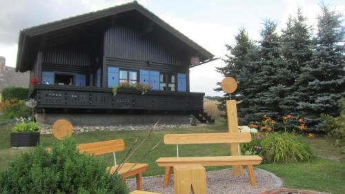 a wooden bench in front of a house at Ferienhaus Ulli in Gansbach