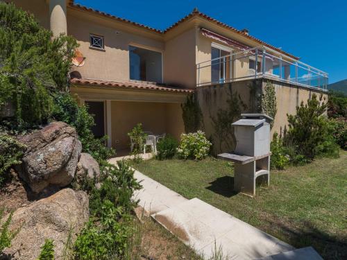 a house with a grill in the yard at Modern villa with private pool in Santʼ Andrea-dʼOrcino