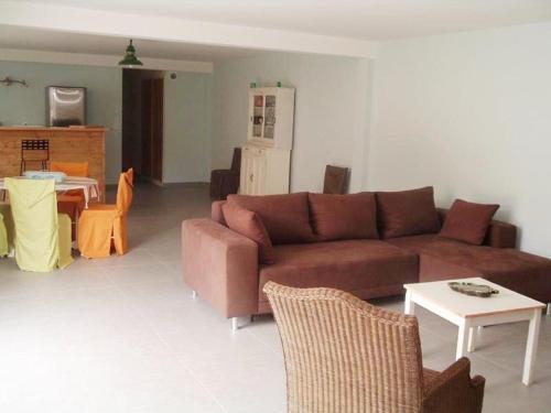 un salon avec un canapé marron et une table dans l'établissement Holiday Home in Ardèche with Pool & Garden, à Fabras