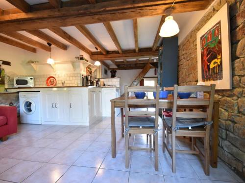 a kitchen and dining room with a table and chairs at Holiday Home in Saizy with Patio in Vignol