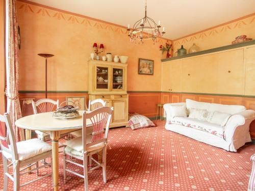 a living room with a table and a couch at Studio in Montbrun Castle with Pool in Montbrun-les-Bains