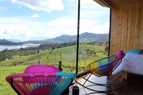 two chairs on a porch with a view of a mountain at Refugio del Neusa in Cogua