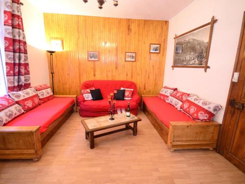 a living room with two red couches and a table at Comfortable Villa in Tignes South of France near Ski Area in Tignes