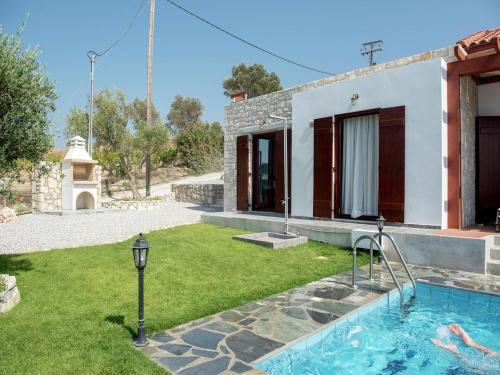 a villa with a swimming pool and a house at Villa in Arkadi with Pool near the Sea in Kiriánna