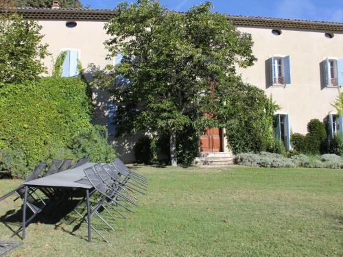 ヴェゾン・ラ・ロメーヌにあるSuperb country house with private poolの建物前のテーブルと椅子
