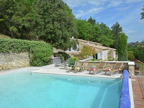 a swimming pool with chairs and a house at Cozy Villa in M nerbes with Swimming Pool in Ménerbes