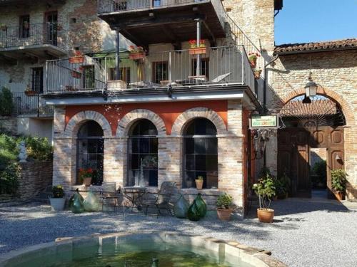 a building with a pool of water in a courtyard at Belvilla by OYO House with large terrace and pool in Bastia Mondovì