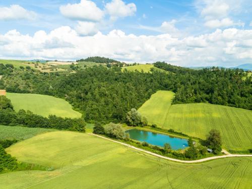 an overhead view of a golf course with a pool of water at Mansion to Relax & Rejuvenate in Perugia