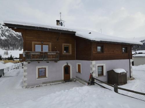 a house in the snow with a balcony at Belvilla by OYO Casa Marinella in Livigno