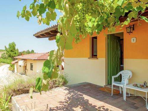 a house with a table and a chair on a patio at Belvilla by OYO Casa Reale Quattro in Valdamonte