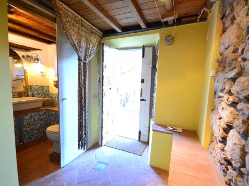 a bathroom with a toilet and a sink and a doorway at Belvilla by OYO Due Cuori in Lucchio