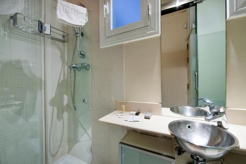 a bathroom with a sink and a shower at Habitat Apartments La Bohème in Barcelona