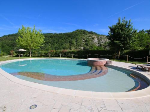 una gran piscina con un banco alrededor en Belvilla by OYO Rosa Gialla, en Apecchio