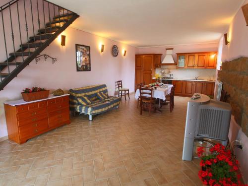 a living room with a kitchen and a dining room at Farmhouse in Sorano with Swimming Pool Terrace Barbecue in Sorano