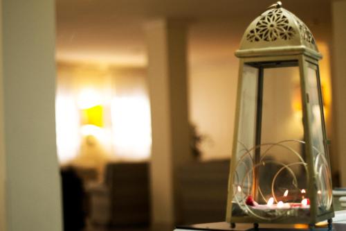 a glass lantern sitting on top of a table at Hotel Diana in Ravenna