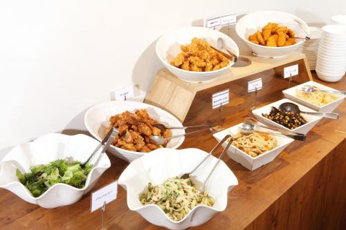 a buffet with different types of food on a table at Hotel Sunriver Shimanto in Shimanto