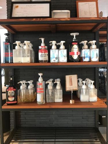 a shelf filled with lots of bottles of soap at Hotel Sunriver Shimanto in Shimanto