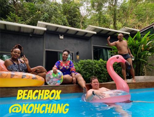 a group of people sitting in the water in a pool at BeachBox@Koh Сhang in Ko Chang