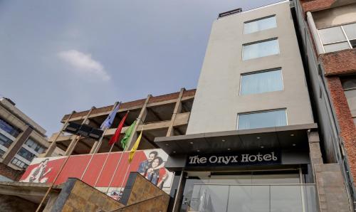 a building with a sign that reads the oxnox house at The Onyx Hotel in Jamshedpur