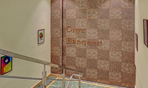 a sign on a wall in a room with a tile floor at The Onyx Hotel in Jamshedpur