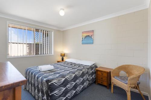a hotel room with a bed and a desk at Apollo Lodge in Toowoomba