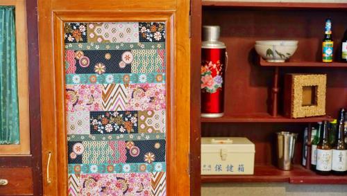 a quilt on a door of a cabinet at Chung Fu Inn in Tainan