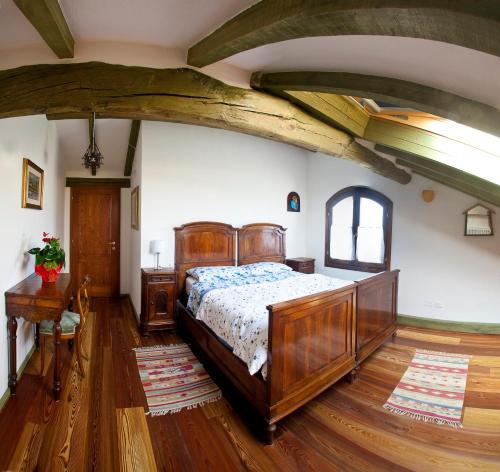 a bedroom with a wooden bed in a room at La Lepre Bianca in Cento