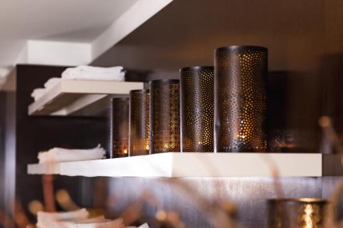 a row of black bottles sitting on a shelf at Familien- & Gartenhotel Theresia 4-Sterne Superior in Saalbach Hinterglemm