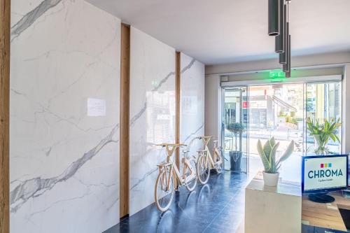 a lobby with two bikes parked against a wall at CHROMA FASHION ROOMS & APARTMENTS in Athens
