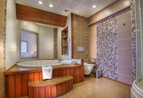 
a bathroom with a tub, sink, and toilet at Best Western Plus Hotel Konak in İzmir
