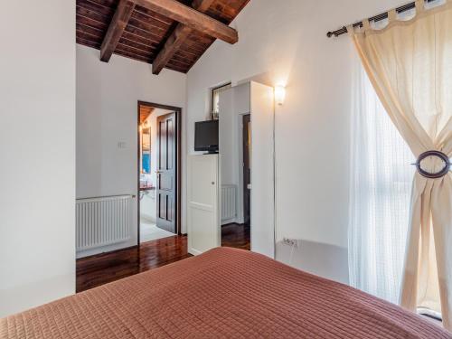 a bedroom with a bed and a large window at Andu's Chalet Azuga in Azuga