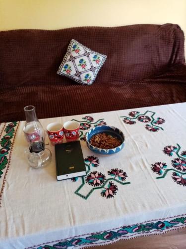a table with a table cloth with a laptop on it at Pensiunea Gură de Rai, Pojorâta in Pojorîta