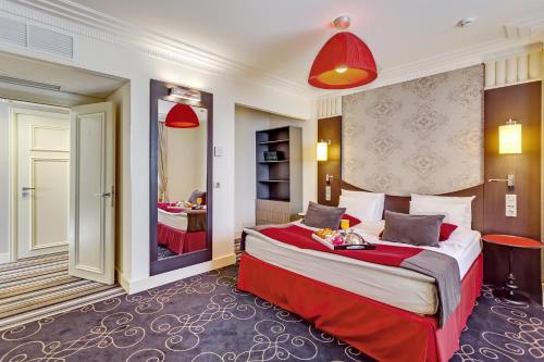 a hotel room with a large bed and a mirror at Mercure Rostov-On-Don Center in Rostov on Don