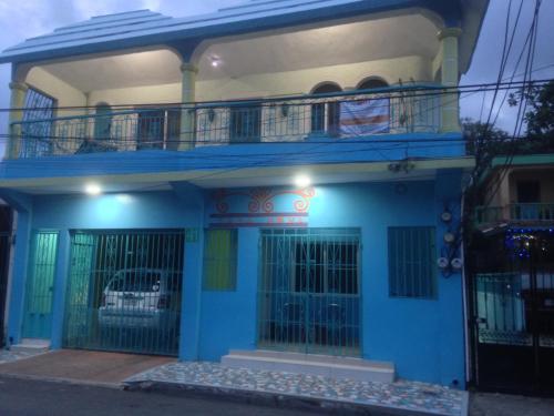 a blue and white house with a balcony at Casa Azul - Apartment in San Felipe de Puerto Plata