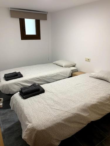 מיטה או מיטות בחדר ב-Apartaments L'Arc