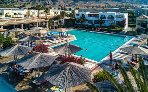 an aerial view of a resort pool with umbrellas at Akti Beach Club in Kardamaina