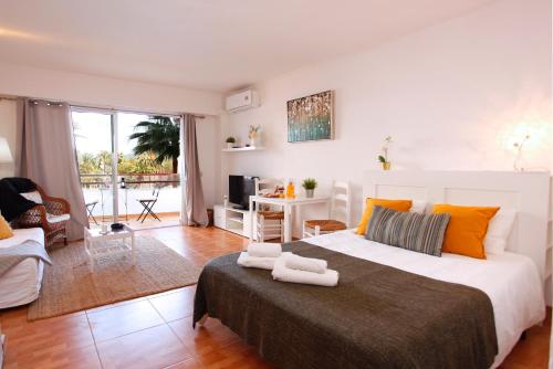 a bedroom with a large bed with two towels on it at Apartamento Can Poma in Alcudia
